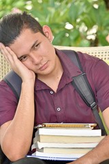 Obraz premium Sad Youthful Filipino Person With Notebooks