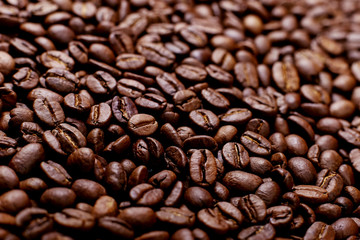 Aroma roasted coffee beans, brown background. Soft focus close up.