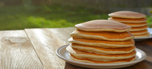 Pancakes. Stack of isolated american pancakes over wooden table. breakfast, food.