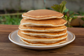 Pancakes. Stack of isolated american pancakes over wooden table. breakfast, food.