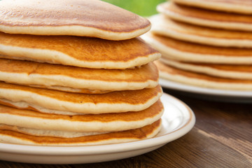 Close up pancakes. Stack of isolated american pancakes over wooden table. breakfast, food.