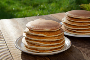 Pancakes. Stack of isolated american pancakes over wooden table. breakfast, food.