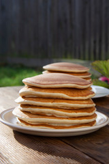 Pancakes. Stack of isolated american pancakes over wooden table. breakfast, food.