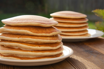 Close up pancakes. Stack of isolated american pancakes over wooden table. breakfast, food.
