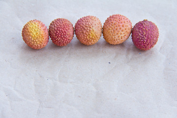 Lychee fruit close-up on packing paper.
