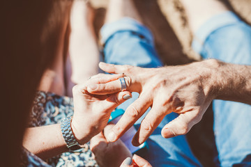 hands of the bride and groom with wedding rings