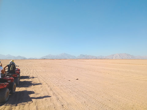 A group of people on quad bikes in the desert of Egypt