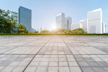 Empty Plaza floor tiles and the skyline of modern urban buildings in Hangzhou..