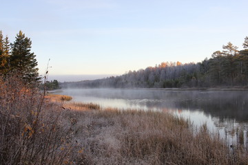 Morning mist over a river in autumn
