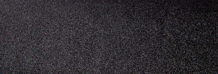 Silver sequins pattern. Sparkling sequins on black wool fabric as background