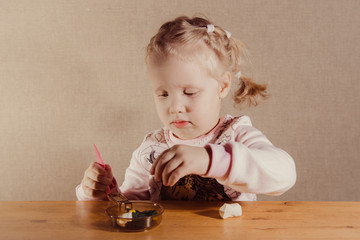 little girl playing with enthusiasm at the table