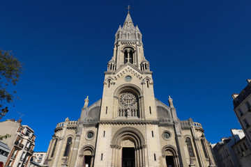 Fototapeta na wymiar The Church of Our Lady of the Holy Cross of Menilmontant is a Roman Catholic parish church located on M nilmontant, in the 20th arrondissement in Paris.
