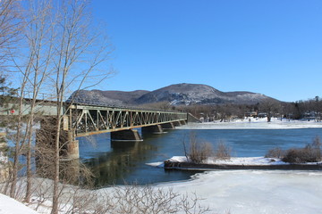 Mont St-Hilaire in winter with the railway bridge viewed from across the Richelieu River
