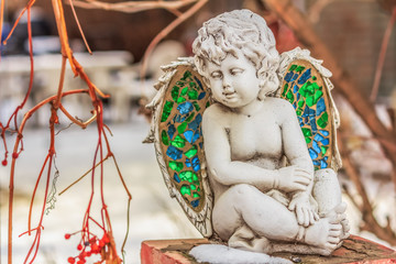 Cupid Angel Statue Sitting on a Brick Post