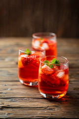Fresh summer cocktail with ice, strawberry and mint