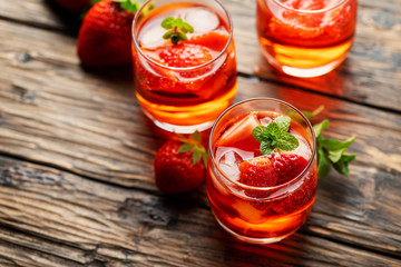 Fototapeta na wymiar Fresh summer cocktail with ice, strawberry and mint
