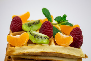 Waffle Put On background, isolate, delicious waffle. waffles with raspberries and tangerine slices. kiwi and mint copy space