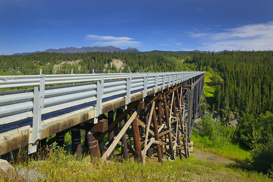 The Kuskulana Bridge over the Kuskulana River on McCarthy Road in the Wrangell Mountains. The Wrangell Mountains are a high mountain range of eastern Alaska, UNESCO World Heritage Site