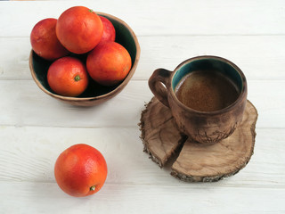 Breakfast with cup of coffee and oranges