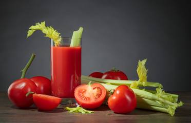 Tomato juice with celery sticks .