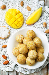 raw vegan mango coconut almond balls with fresh mango