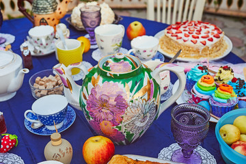 Tea party with cupcakes and different colorful cups