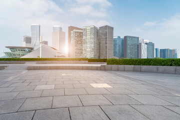 Empty Plaza floor tiles and the skyline of modern urban buildings in Hangzhou..