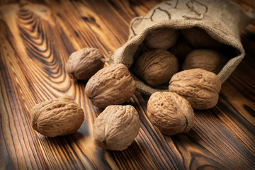 Walnuts on the table and in a jute bag