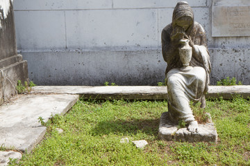 Marble sculpture of robed seated woman with funerary urn from Lafayette Cemetery #1 in the Garden...