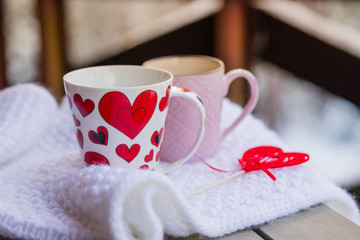 Cups of tea or coffee with steam,heart shape on blurred background. Valentine's day celebration or love concept. Copy space.love and coffee, hot drinks outdoor, on Balcony,terrace, patio.Romantic