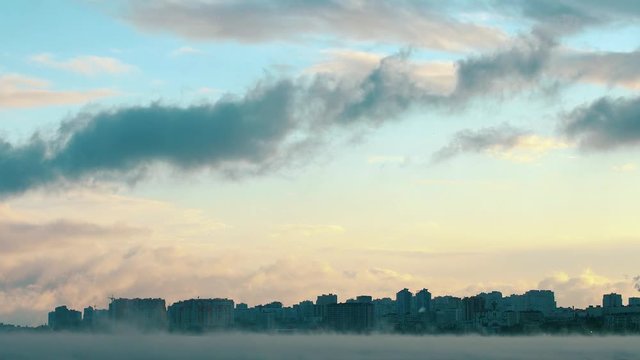 Beautiful sunset of the port city against the background of the evaporating cold sea