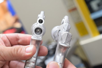 Before and after machining a spray gun in a factory.