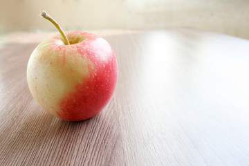 red apple on wooden table
