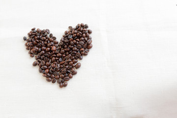 coffee beans in shape of heart on white background