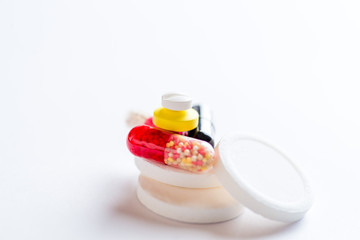 set of multi-colored pills and capsules on a white background