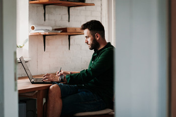 Young casual man working on a laptop