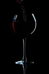 wine in glass on black background
