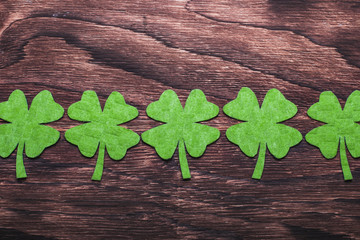 Green clover leaf on wooden background
