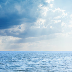 Obraz na płótnie Canvas blue sea and low clouds over it