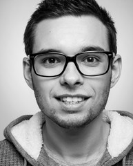 Portrait of a handsome guy with glasses. Poor eyesight. Vision correction. Black and white photography