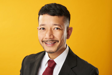 Headshot of smiling asian man