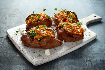 Roast sweet potato stuffed with feta cheese and kale. healthy food