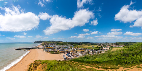 Fototapeta na wymiar BRIDPORT, DORSET, UK - 6JUN2018: West Bay from cliffs to the East. Inland, the town of Bridport can also be seen.