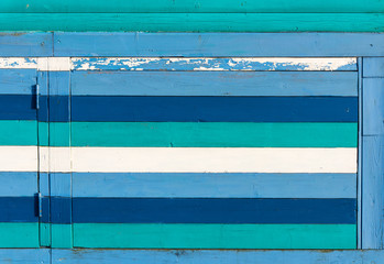 Section of blue, gren and white wood panelling from a seaside beach hut. Perfect as a background for Summer Holiday or seaside themes.