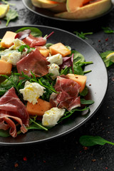 Parma ham and melon salad with mozzarella, green leaves mix