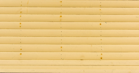 Section of ochre wood panelling from a seaside beach hut. Perfect as a background for Summer Holiday or seaside themes.