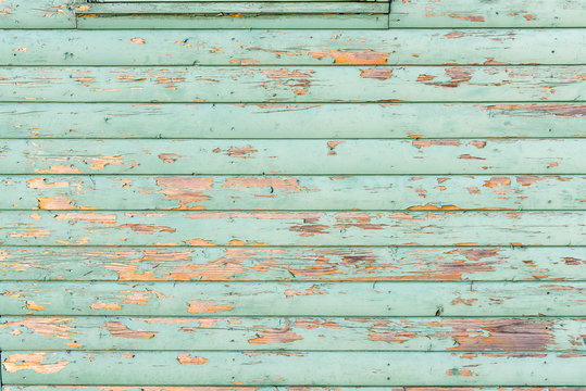 Section of light green distressed wood panelling from a seaside beach hut. Perfect as a background for Summer Holiday or seaside themes.