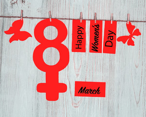 Women's Day Concept. The symbol of Venus. Pined on the clothespins paper figure eight and...