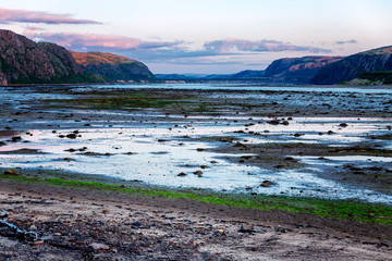 Beautiful pink sunset on the sea, mountain landscape