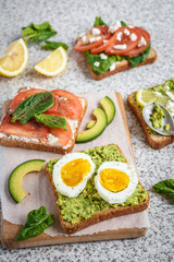 Healthy avocado and egg toasts. Toast, avocado, egg, tomatoes, spinach, cheese Feta, lemon. Organic healthy food. Clean healthy eating
